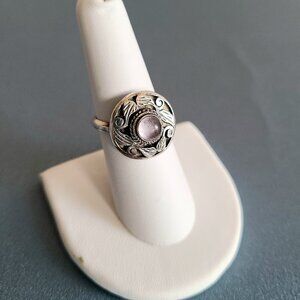 Sterling silver 925 ring with floral design and round Amethyst(?) stone.